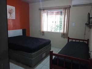 A bed or beds in a room at 261 - Casa de Praia Armacao de Itapocoroi