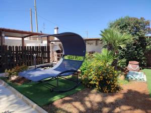 a blue chair sitting in a yard at Le Due Palme in Marsala