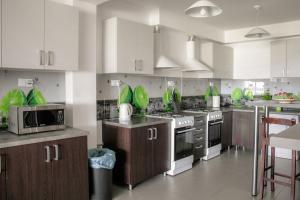 a kitchen with white cabinets and stainless steel appliances at Bielik in Dęblin