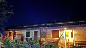 a brick house with a light on the side of it at Pousada Brasil - São Miguel do Gostoso in São Miguel do Gostoso