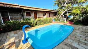 a swimming pool with a swan in a yard at Pousada Brasil - São Miguel do Gostoso in São Miguel do Gostoso