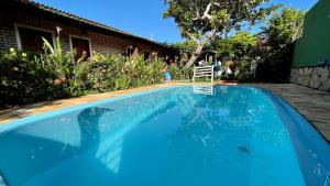 a large blue swimming pool in front of a house at Pousada Brasil - São Miguel do Gostoso in São Miguel do Gostoso