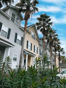 a large house with palm trees in front of it at 3 Story Lake House Near Historic Downtown in Charleston