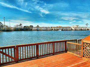 a view of a river from a wooden deck at 3 Story Lake House Near Historic Downtown in Charleston