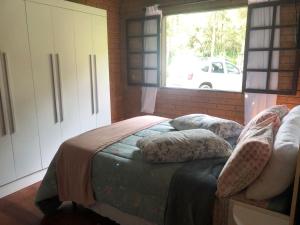 A bed or beds in a room at Casa de Campo Meu Pequeno Paraíso