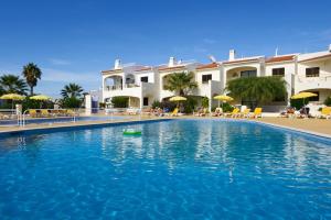 a swimming pool in front of a resort at Monte Dourado in Carvoeiro