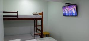 a room with a bunk bed and a picture on the wall at POUSADA DA MAGA in Chapada dos Guimarães