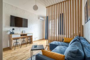 a living room with a blue couch and a table at Princess Milena Apartments - Studio Balsa in Bečići