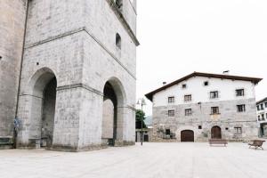 a large stone building with a bench in front of it at Arangiz Etxea in Aulestia