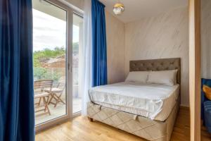 a bedroom with a bed and a balcony at Princess Milena Apartments - Studio Balsa in Bečići