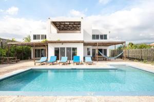a villa with a swimming pool and a house at Turtles Nest Villa in Treasure Beach
