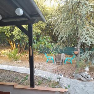 a patio with two chairs and a table at Argelliers in Argelliers