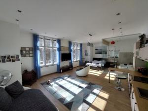 a living room with a couch and a table at Sunny Studio at the Castle in Budapest