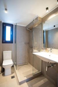 a bathroom with a toilet and a sink and a shower at Marineiko Luxury Apartments in Ierissos +87 photos