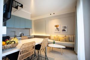 a kitchen and living room with a table and chairs at Marineiko Luxury Apartments in Ierissos