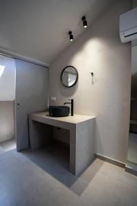 a bathroom with a sink and a mirror on the wall at Marineiko Luxury Apartments in Ierissos