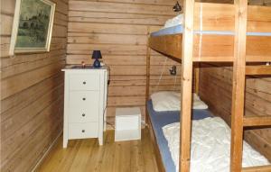 a bedroom with two bunk beds and a night stand at Solbakken in Vikersund