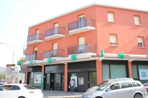 a orange building with cars parked in front of it at Nuovo Hotel San Martino snc in Casalecchio di Reno