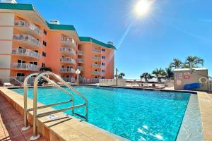 a swimming pool in front of a resort at Beach Cottage 1405 in Clearwater Beach