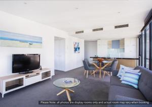a living room filled with furniture and a tv at The Sebel Residences Melbourne Docklands Serviced Apartments in Melbourne