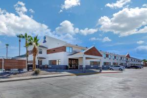 a large white building with a parking lot at Best Western Blythe in Blythe