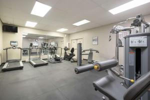 a gym with several treadmills and machines at SureStay Plus Hotel by Best Western McGuire AFB Jackson in Cookstown