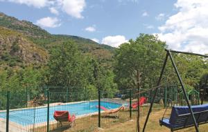 a playground with a swimming pool in front of a mountain at 1 Bedroom Amazing Home In Mayres in Mayres