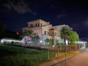 a large house with a fence in front of it at night at Luxury Villa Ulcinj in Ulcinj