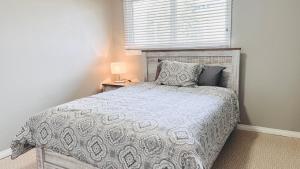 a bedroom with a bed and a window at Lovely 2 Bedroom apartment in Camrose