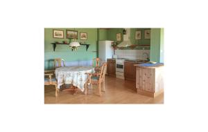 a kitchen with a table and a table and chairs at Nice Home In Dals Lnged With 2 Bedrooms in Dals Långed