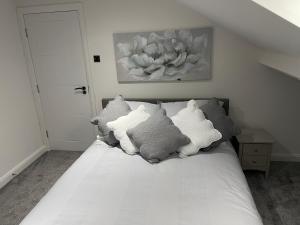a bed with pillows on it in a bedroom at The Welcome Apartment in Blackpool
