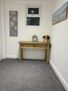 a wooden desk in a room with a window at The Welcome Apartment in Blackpool