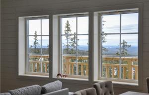 a room with three windows with a view at Nice Home In Slen With Sauna And 7 Bedrooms in Sälen