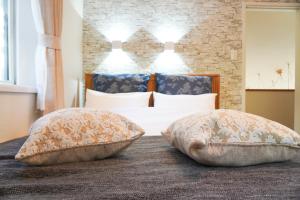 Ένα ή περισσότερα κρεβάτια σε δωμάτιο στο Tiz wan 野島江崎