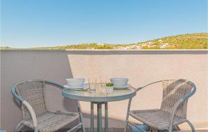 a small table and two chairs on a balcony at 2 Bedroom Amazing Apartment In Kanica in Zaglavice