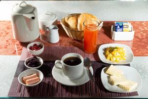 a breakfast table with a cup of coffee and food at Hotel La Posada de Ugarte in Arequipa