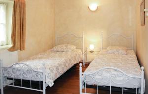 two beds sitting next to each other in a bedroom at Cozy Home In Montsegur Sur Lauzon in Montségur-sur-Lauzon +34 photos
