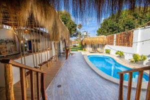 a resort with a swimming pool next to a building at Hotel Boutique Beso de Sal in Colán