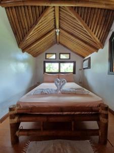 a bedroom with a bed with a heart decoration on it at Paras Inn Boracay in Boracay