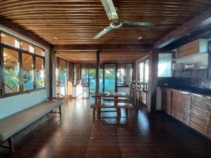 a room with tables and benches in a building with windows at Paras Inn Boracay in Boracay