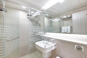 a bathroom with a sink and a glass shower at Kumho Seorak Resort in Sokcho