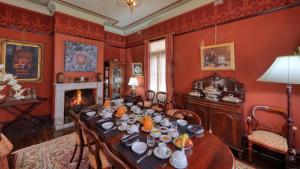 a dining room with a table and a fireplace at Grenfell Hall in Grenfell