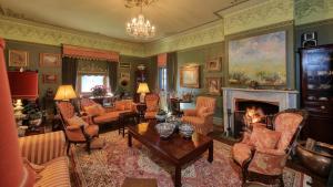 a living room filled with furniture and a fireplace at Grenfell Hall in Grenfell
