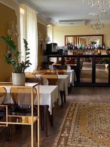 een restaurant met tafels en stoelen en een bar bij Ziemupes Muiža & SPA in Ziemupe