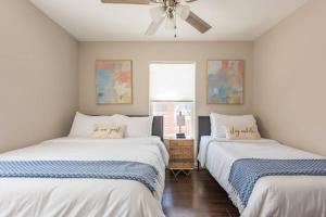 two beds in a room with a ceiling fan at MODERN DOWNTOWN HOME CLOSE TO THE RIVERWALK, PEARL AND AT&T CENTER in San Antonio