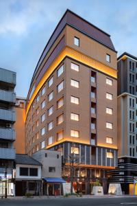 a large building with lights on the side of it at Sora Niwa Terrace Kyoto in Kyoto