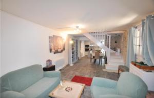 uma sala de estar com um sofá azul e uma escada em Lovely Home In Laroque Des Alberes With Private Swimming Pool, Can Be Inside Or Outside em Laroque-des-Albères