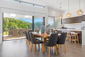 a kitchen and dining room with a wooden table and chairs at Coastal Chic in Saint Andrews Beach