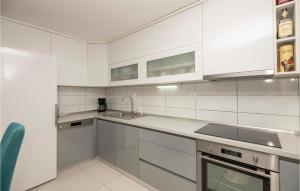 a white kitchen with white cabinets and a sink at Nice Home In Vinjani Donji in Donji Vinjani +37 photos