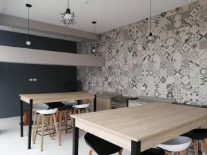 a kitchen with two tables and bar stools at MODERNO LOFT BARRANCO, VISTA PANORAMICA in Lima